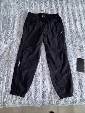 Nike Nocta Black Track Pants with Yellow Tag